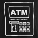 Front of ATM machine to buy travel insurance.